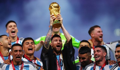 O argentino Lionel Messi levanta o troféu da Copa do Mundo ao lado de companheiros de equipe enquanto comemoram após a vitória sobre a França na Copa do Mundo. Foto: REUTERS/Kai Pfaffenbach
